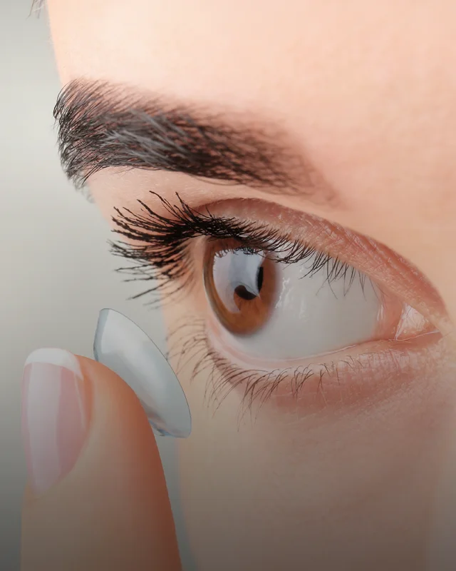A woman putting a soft lens contact into her eye