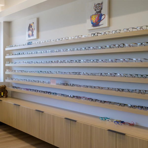 Racks of eyeglasses on the wall of Elevation Vision